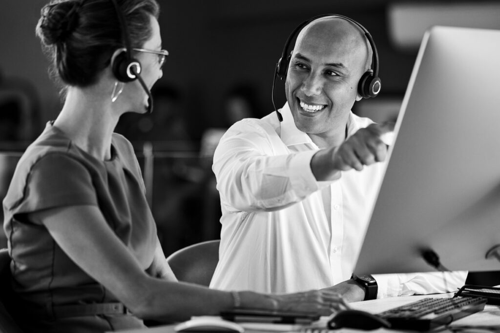 Online customer service operatives go through training at a computer.